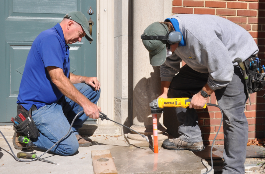 Outdoor lighting experts installing hardscape lights